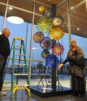 Former Sequim city manager Steve Burkett and Sue Ellen Riseau, executive director of the Olympic View Community Foundation, unveil a sculpture at the Sequim Civic Center on Friday, Feb. 5, dedicated to Burkett's late wife, Bobbi.— image credit: Sequim Gazette photo by Michael Dashiell